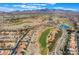 Stunning aerial view of a golf course community with mountain backdrop and lush green landscaping at 3057 Sunrise Heights Dr, Henderson, NV 89052
