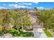 An aerial view of a well-maintained home with desert landscaping, tile roof, and mountain views at 3057 Sunrise Heights Dr, Henderson, NV 89052