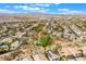 An aerial view of a community landscape with desert landscape, trees and homes at 3057 Sunrise Heights Dr, Henderson, NV 89052