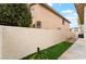 A home's backyard showcasing a wall, grass, and a walkway at 3057 Sunrise Heights Dr, Henderson, NV 89052