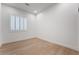 Cozy room with white walls, hardwood floors, and a large window with plantation shutters at 3057 Sunrise Heights Dr, Henderson, NV 89052