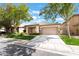 Charming single-story home featuring a two-car garage, desert landscaping, and covered front porch at 3057 Sunrise Heights Dr, Henderson, NV 89052