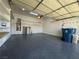 Spacious garage featuring epoxy floor, water heater, storage, and room for vehicles at 3057 Sunrise Heights Dr, Henderson, NV 89052
