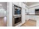 Kitchen features stainless steel double ovens and white cabinets at 3057 Sunrise Heights Dr, Henderson, NV 89052