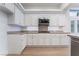 Kitchen features white cabinets, light countertops, and stainless steel appliances at 3057 Sunrise Heights Dr, Henderson, NV 89052