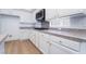 Kitchen features white cabinets, light countertops, and stainless steel appliances at 3057 Sunrise Heights Dr, Henderson, NV 89052