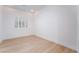 Bright room with wood floors, window with shutters, and white walls at 3057 Sunrise Heights Dr, Henderson, NV 89052
