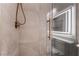 Shower with stone tile, brushed gold fixtures, and a glass door at 3057 Sunrise Heights Dr, Henderson, NV 89052