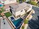 Aerial view of the backyard featuring a modern pool, lounge chairs, and artificial turf at 3062 Echoed Rondel Ln, Henderson, NV 89044