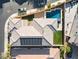 Aerial view of a home with a pool, well-maintained landscaping, and solar panels on the roof at 3062 Echoed Rondel Ln, Henderson, NV 89044