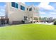 Spacious backyard featuring artificial turf, pool, covered patio, and barbecue area at 3062 Echoed Rondel Ln, Henderson, NV 89044