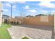 Gravel-covered dog run in backyard is secured by fencing and artificial turf at 3062 Echoed Rondel Ln, Henderson, NV 89044