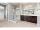 Elegant bathroom showcasing a glass shower and vanity with a large mirror at 3062 Echoed Rondel Ln, Henderson, NV 89044