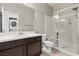 Bathroom with a glass-enclosed shower, wood vanity, and access to laundry for added convenience at 3062 Echoed Rondel Ln, Henderson, NV 89044