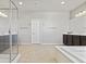 Spacious bathroom with a stand up shower, dual vanity with dark cabinets, and a soaking tub at 3062 Echoed Rondel Ln, Henderson, NV 89044