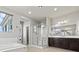 Bright primary bath featuring a stand up shower, dual vanity with dark cabinets, and a soaking tub at 3062 Echoed Rondel Ln, Henderson, NV 89044