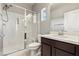 Bathroom features a glass shower with marble-esque tile surround, a seat, and dark wood vanity at 3062 Echoed Rondel Ln, Henderson, NV 89044
