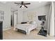 Cozy bedroom featuring a ceiling fan, neutral decor, and a stationary bike for fitness enthusiasts at 3062 Echoed Rondel Ln, Henderson, NV 89044