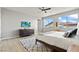 Well-lit bedroom featuring a comfy bed, large windows and a wall-mounted TV at 3062 Echoed Rondel Ln, Henderson, NV 89044