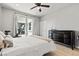 Bright bedroom with light wood floors, a ceiling fan, and patio access at 3062 Echoed Rondel Ln, Henderson, NV 89044