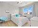 Bright bedroom featuring a white bed frame, light wood floors, and a large window at 3062 Echoed Rondel Ln, Henderson, NV 89044