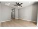 Spacious bedroom with a ceiling fan, neutral walls, and wood flooring offering a serene atmosphere at 3062 Echoed Rondel Ln, Henderson, NV 89044