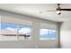 Bright bedroom featuring two windows, a ceiling fan, and neutral walls at 3062 Echoed Rondel Ln, Henderson, NV 89044