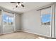 Bright bedroom features wood floors, a ceiling fan, and two windows at 3062 Echoed Rondel Ln, Henderson, NV 89044