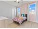 Charming bedroom with light wood floors, ceiling fan, and abundant natural light at 3062 Echoed Rondel Ln, Henderson, NV 89044