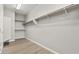 Walk-in closet with wooden floors and multiple shelves at 3062 Echoed Rondel Ln, Henderson, NV 89044