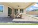 Relaxing covered patio with neutral toned furniture and a view of the yard at 3062 Echoed Rondel Ln, Henderson, NV 89044