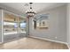 Bright dining room featuring wood floors, modern chandelier, and sliding glass doors to backyard pool at 3062 Echoed Rondel Ln, Henderson, NV 89044