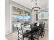 Dining area with views of the backyard, pool, and covered patio with hanging chandelier above table at 3062 Echoed Rondel Ln, Henderson, NV 89044