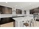 Stylish kitchen with a large center island, dark cabinets, stainless steel appliances, and a modern design at 3062 Echoed Rondel Ln, Henderson, NV 89044