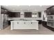 Bright kitchen with stainless steel appliances, dark cabinets, and white countertops at 3062 Echoed Rondel Ln, Henderson, NV 89044