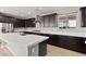 Contemporary kitchen with stainless steel appliances, dark cabinets, and white countertops at 3062 Echoed Rondel Ln, Henderson, NV 89044