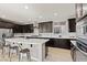 Modern kitchen with a large island, dark cabinets, stainless steel appliances, and ample counter space at 3062 Echoed Rondel Ln, Henderson, NV 89044