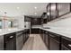 Spacious kitchen featuring dark cabinetry, stainless steel appliances, and a large island at 3062 Echoed Rondel Ln, Henderson, NV 89044