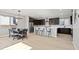Spacious kitchen with dark cabinetry, a large island, and modern appliances adjacent to the dining area at 3062 Echoed Rondel Ln, Henderson, NV 89044