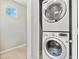 Efficient laundry area featuring a stacked washer and dryer, maximizing space and convenience at 3062 Echoed Rondel Ln, Henderson, NV 89044
