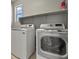 Bright laundry room features a washer and dryer and overhead storage shelf at 3062 Echoed Rondel Ln, Henderson, NV 89044