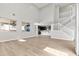 Open-concept living room with hardwood floors, large windows, and stairs at 3062 Echoed Rondel Ln, Henderson, NV 89044