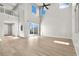 Bright living room with hardwood floors, high ceilings, and sliding glass doors to backyard at 3062 Echoed Rondel Ln, Henderson, NV 89044