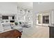 Bright and airy living room with high ceilings, a large sectional sofa, and sliding doors to the patio at 3062 Echoed Rondel Ln, Henderson, NV 89044