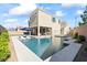 Beautiful backyard with a refreshing pool, sun loungers, and covered patio seating area at 3062 Echoed Rondel Ln, Henderson, NV 89044