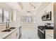 Modern kitchen features stainless steel appliances, a double sink, and a bright breakfast nook with lots of windows at 3314 Astoria Dr, Las Vegas, NV 89121