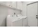 Functional laundry room with white appliances and ample storage cabinets at 3314 Astoria Dr, Las Vegas, NV 89121