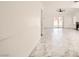 Spacious living room featuring marble-like tile flooring, ceiling fan, and sliding glass doors for seamless indoor-outdoor living at 3314 Astoria Dr, Las Vegas, NV 89121