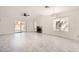 Bright living room boasts a fireplace, stylish light fixture, ceiling fan, and sliding glass doors to the backyard at 3314 Astoria Dr, Las Vegas, NV 89121
