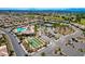 Beautiful aerial view of community amenities including a pool, tennis courts, and bocce ball courts at 3335 American Mustang Ct, Las Vegas, NV 89122